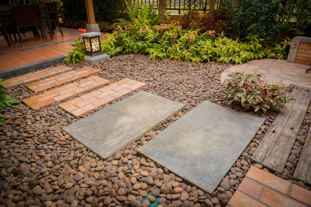 Decorative garden with pebbles and stepping stones as a pathway.