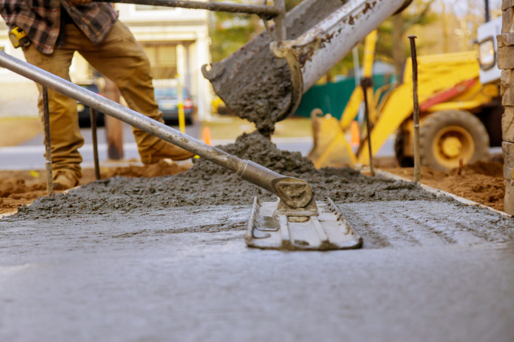 Worker working for concrete pavement for ground at construction
