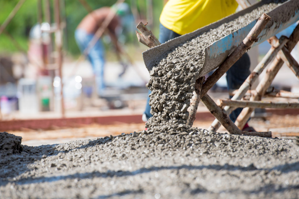 A commercial concrete supplier in Hobbs pouring concrete for a construction project.