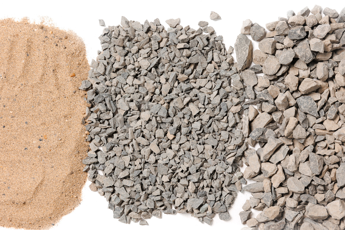 Sand and two different sizes of gravel against a white background in Hobbs.